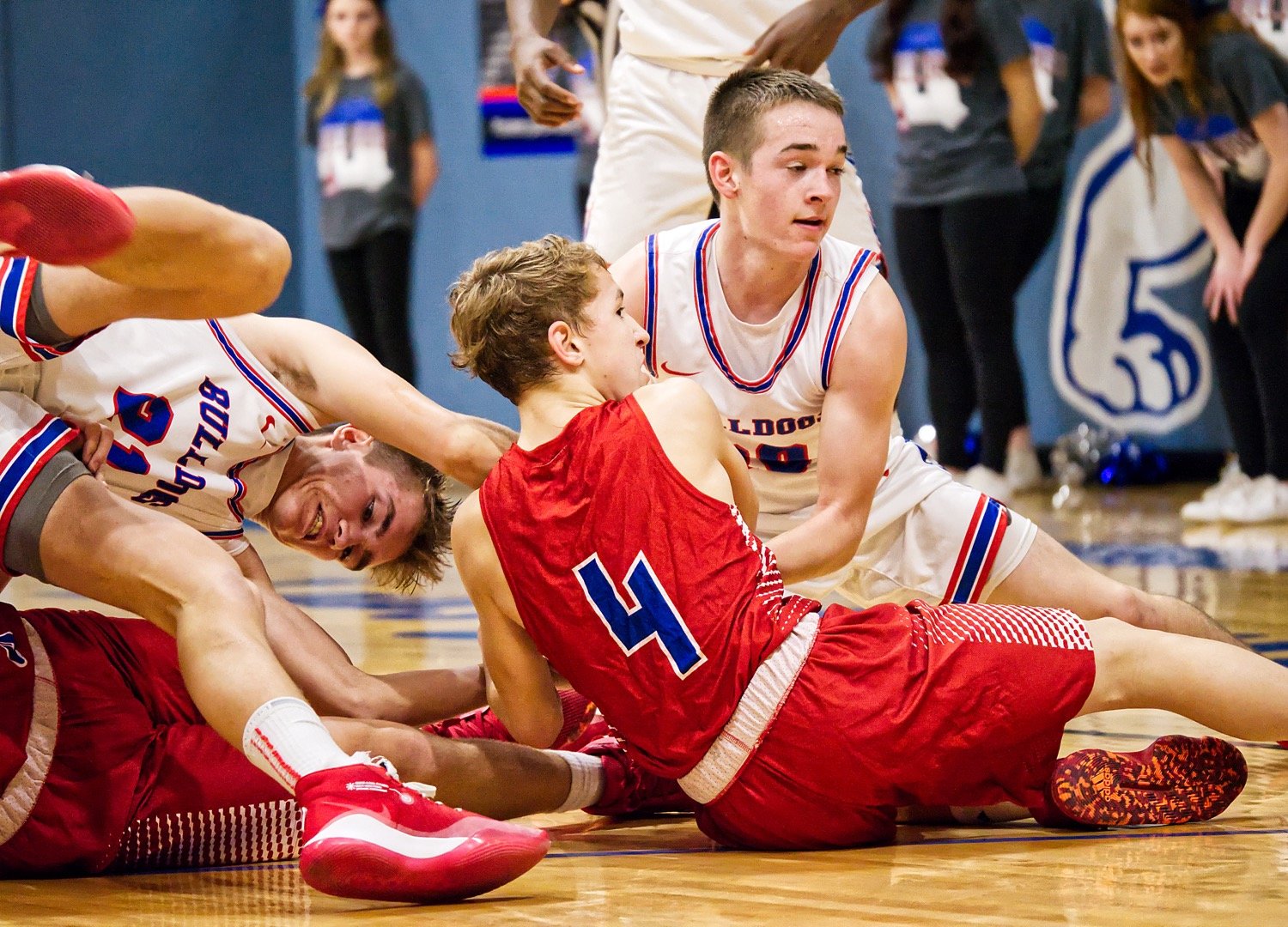 Ben Burroughs and Ford Tannebaum of Quitman and Will Hartin of Alba-Golden tussle for a loose ball in last week’s cross-county district rivalry.